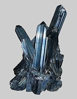 Stibnite crystals: long, lead-grey metallic blades