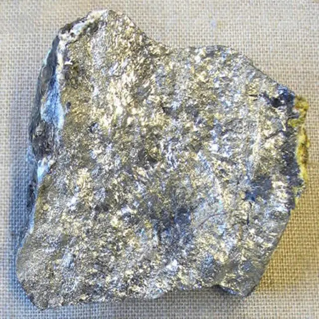 A piece of antimony ore with a bright metallic grey lustre